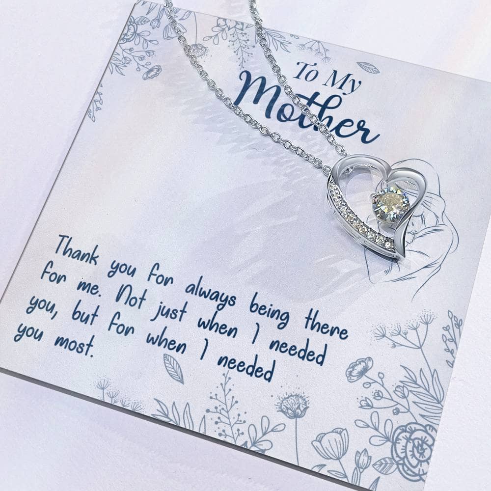 Alt text: "Close-up of a heart-shaped necklace on a card from the Personalized Mother Necklace Collection - From Child's Heart To Mom's"