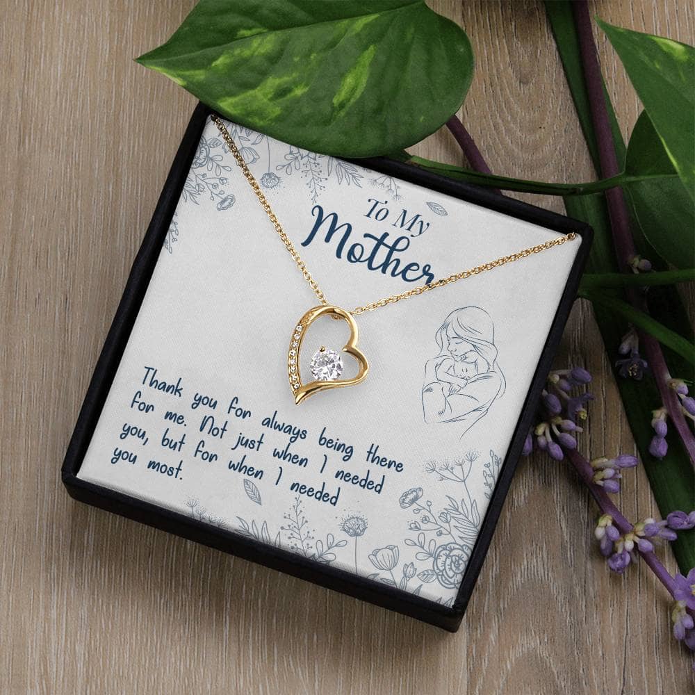 Alt text: "Personalized Mother Necklace - A necklace in a box with a note, featuring a heart-shaped pendant and a gold chain. Symbolizes the unbreakable bond between a mother and child. Perfect gift for any occasion."