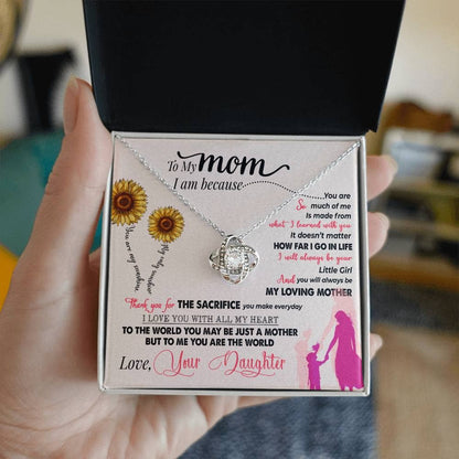 Alt text: "A hand holding a Personalized Mother Necklace in a box, symbolizing love and connection."