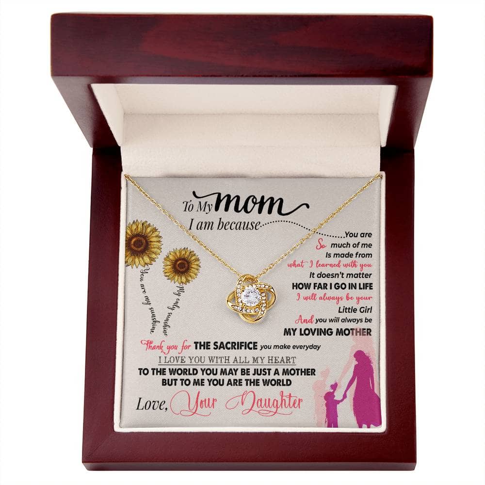 A close-up image of a Personalized Mother Necklace in a box, featuring a heart-shaped pendant. The necklace is made of premium materials and adorned with cushion-cut cubic zirconia stones. It comes in an elegant mahogany-style box with LED lighting for a magical unboxing experience.