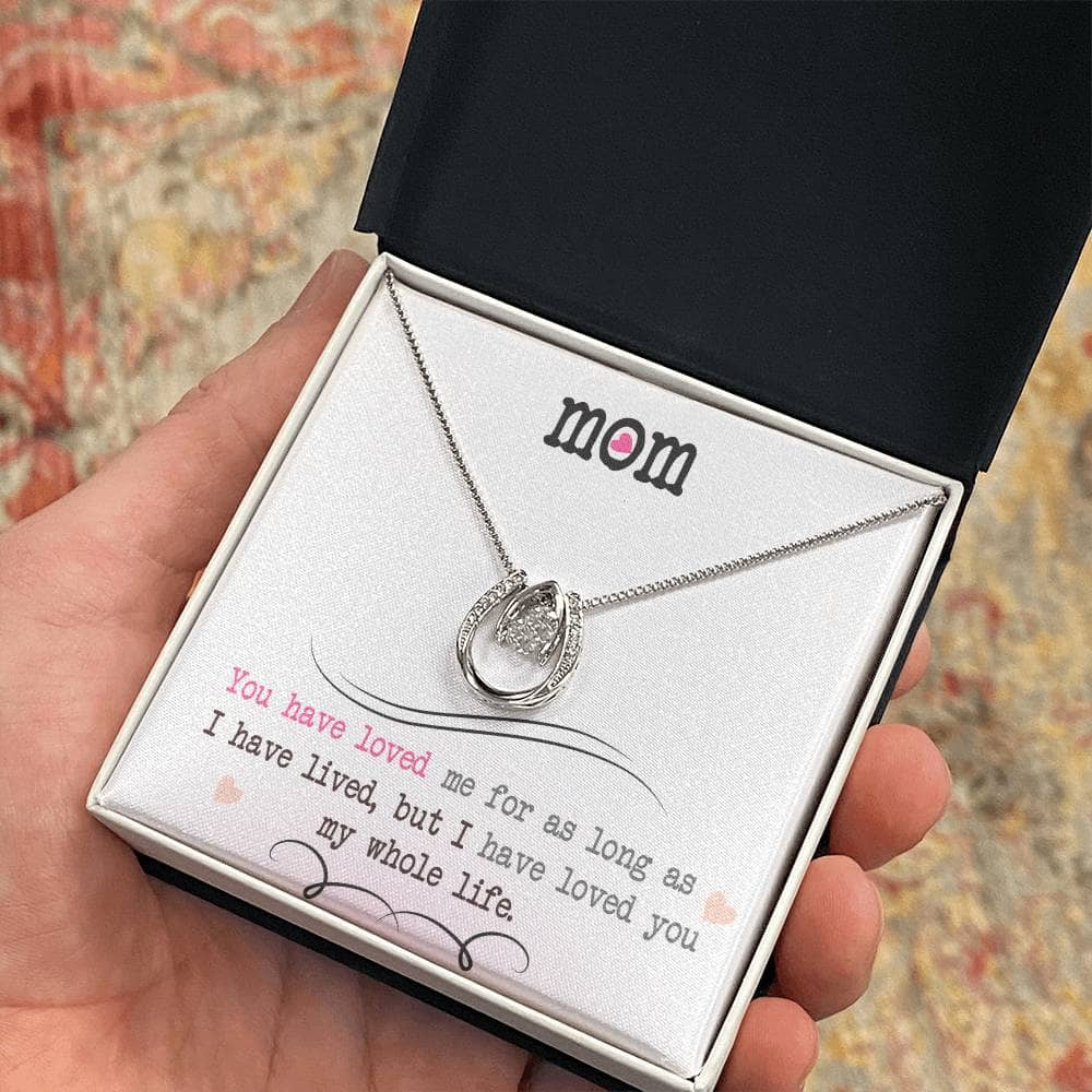 Alt text: "A hand holding a Personalized Mother Necklace in a box, symbolizing the infinite love and care of a mother-child relationship."