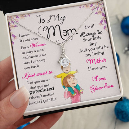 A hand holding a Personalized Mother Necklace - Gift From Son Or Daughter, featuring a heart-shaped pendant with a picture of a child.