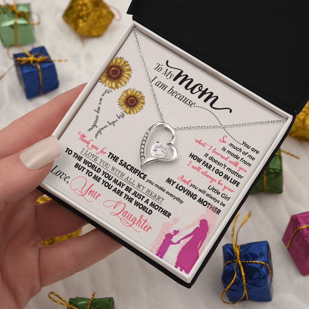 Alt text: A hand holding a Personalized Mother Necklace in a box