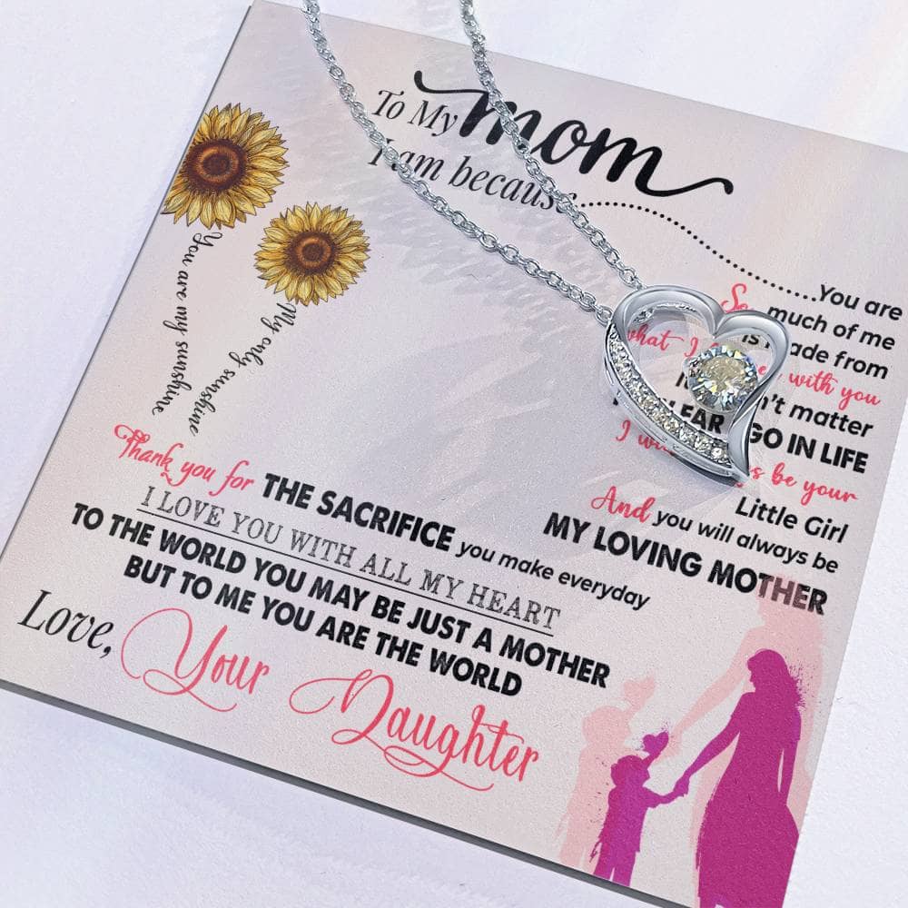 Alt text: "Close-up of heart-shaped necklace on a card from the Personalized Mother Necklace Collection, symbolizing the bond between mothers and children."
