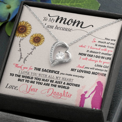 Alt text: "Personalized Mother Necklace - A necklace in a box with a heart-shaped pendant, adorned with cushion-cut cubic zirconias, symbolizing the bond between mothers and children."