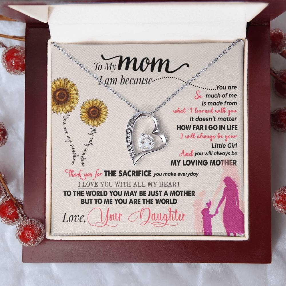 Alt text: "Personalized Mother Necklace - Heart-shaped pendant with cushion-cut cubic zirconias in a box"