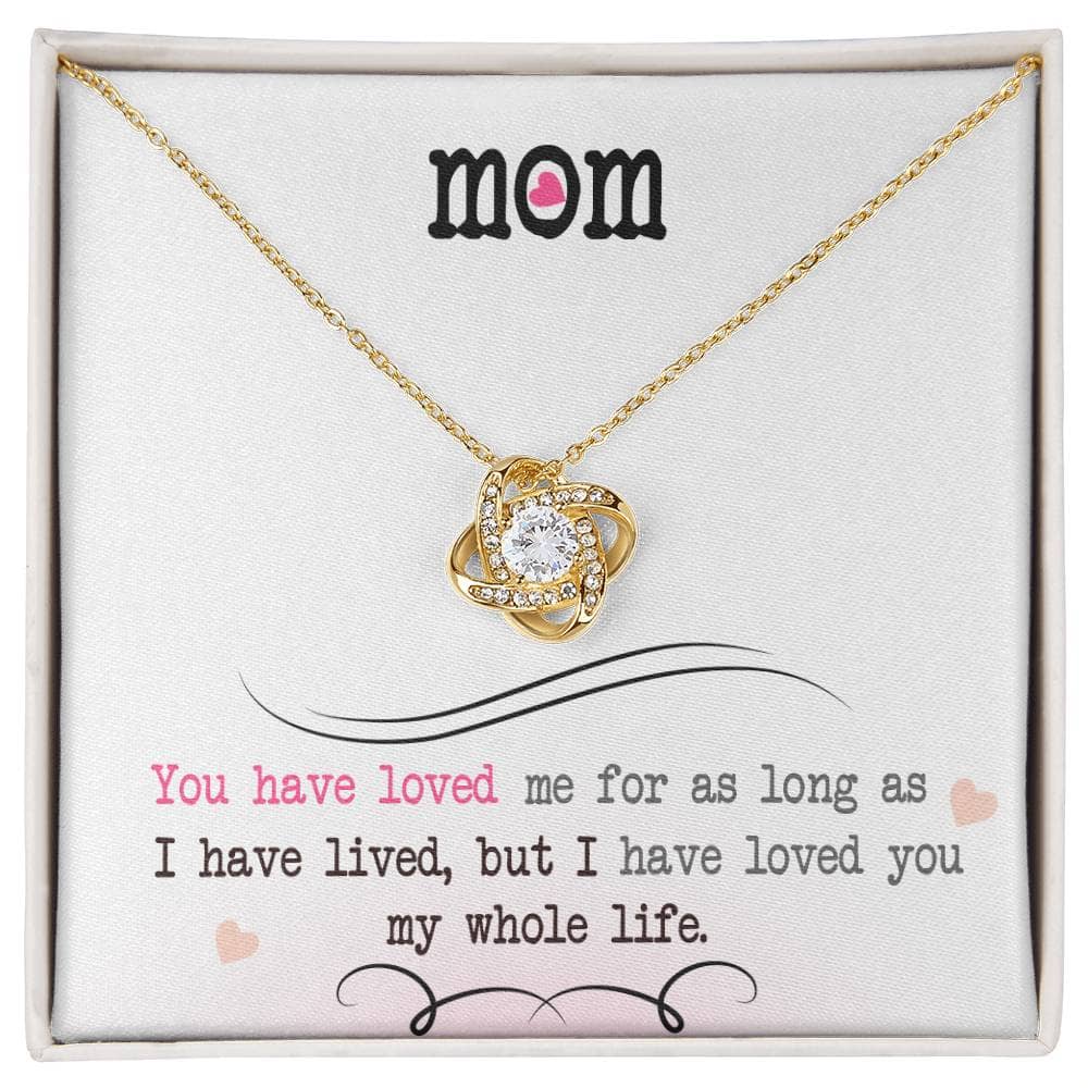 A close-up image of a gold necklace with a diamond pendant in a box from the Personalized Mother Necklace - Love Knot Jewelry collection.
