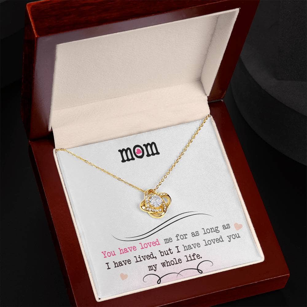 Alt text: "Personalized Mother Necklace - Love Knot Jewelry: A stunning necklace in a box with a heart-shaped pendant adorned with cubic zirconia crystals, symbolizing the unbreakable bond between a mother and child. Adjustable chain included."