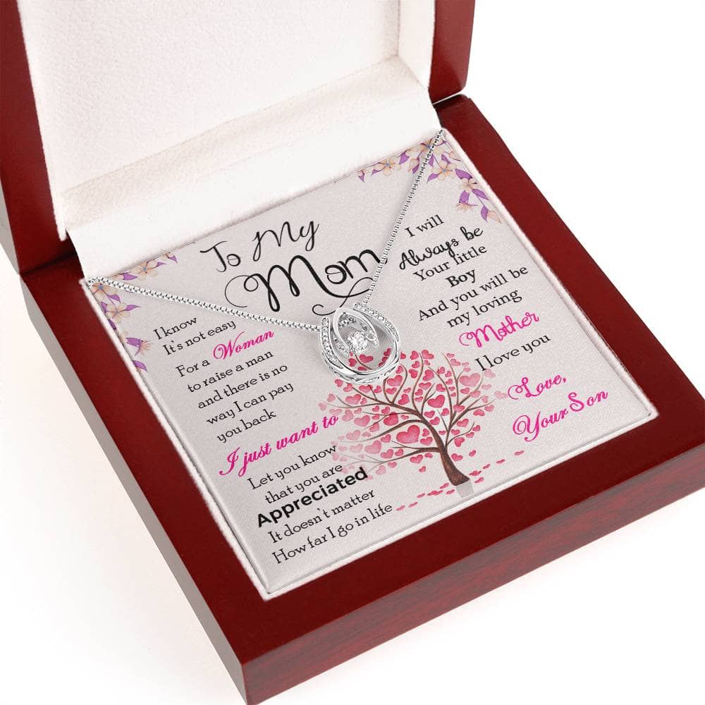 Alt text: "Personalized Mother Necklace in a box, adorned with cubic zirconia, symbolizing a mother's love and care. Adjustable chain for diverse preferences. Presented in a luxurious mahogany-styled box with LED lighting."