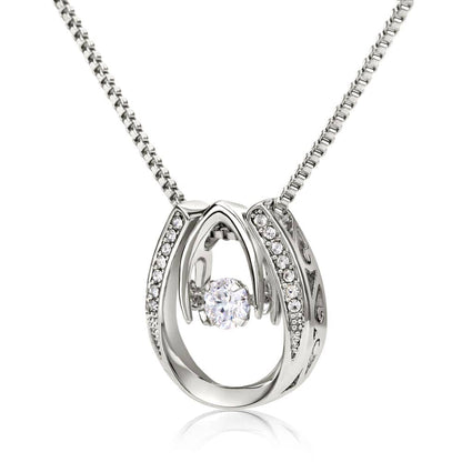 Alt text: "Silver necklace with diamond pendant, a symbol of a mother's love and care. Adorned with cubic zirconia, adjustable chain included. Packaged in a luxurious mahogany-styled gift box."