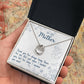Alt text: "A hand holding a personalized mother necklace in a box, featuring a heart-shaped pendant and cushion-cut cubic zirconia."