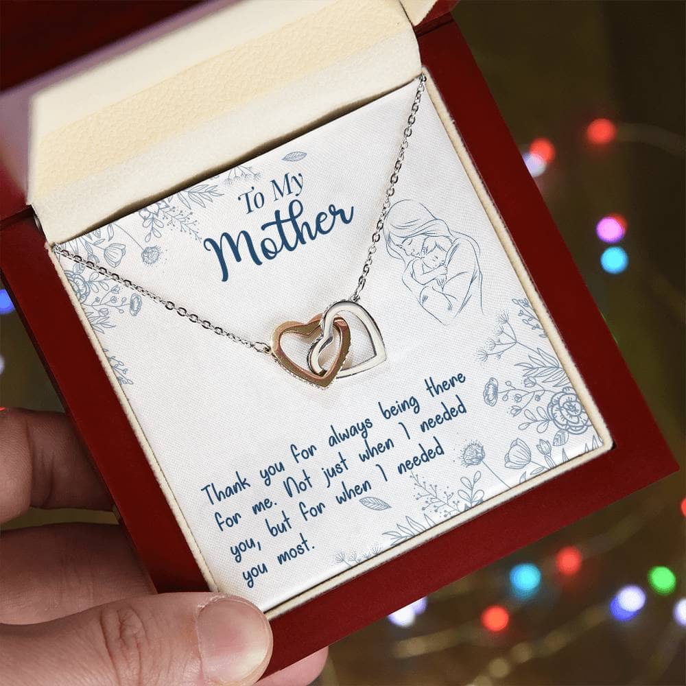 Alt text: "A hand holding a Personalized Mother Necklace in an elegant box with LED lighting"