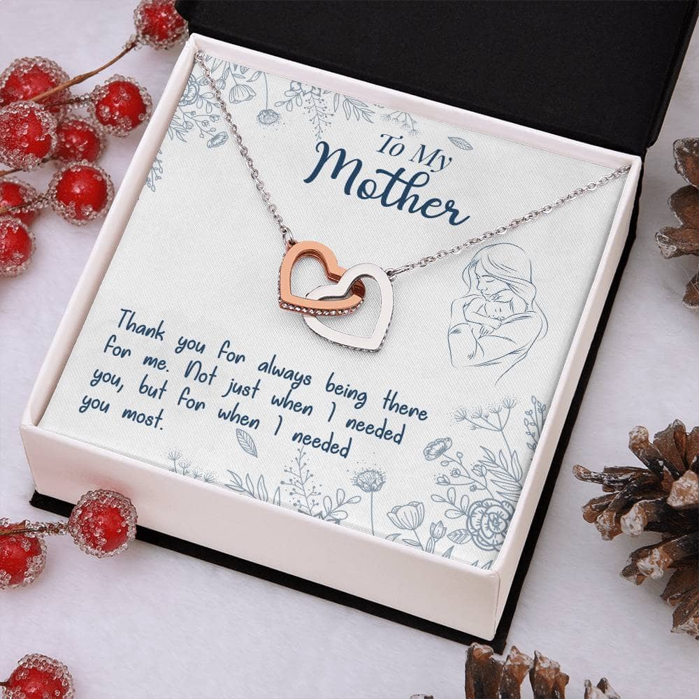 Alt text: "Personalized Mother Necklace - A necklace in a box with pine cones and berries, symbolizing the unshakable bond between mother and child. Made with top-grade materials, featuring a heart-shaped pendant and adjustable chains. Perfect gift for any occasion."