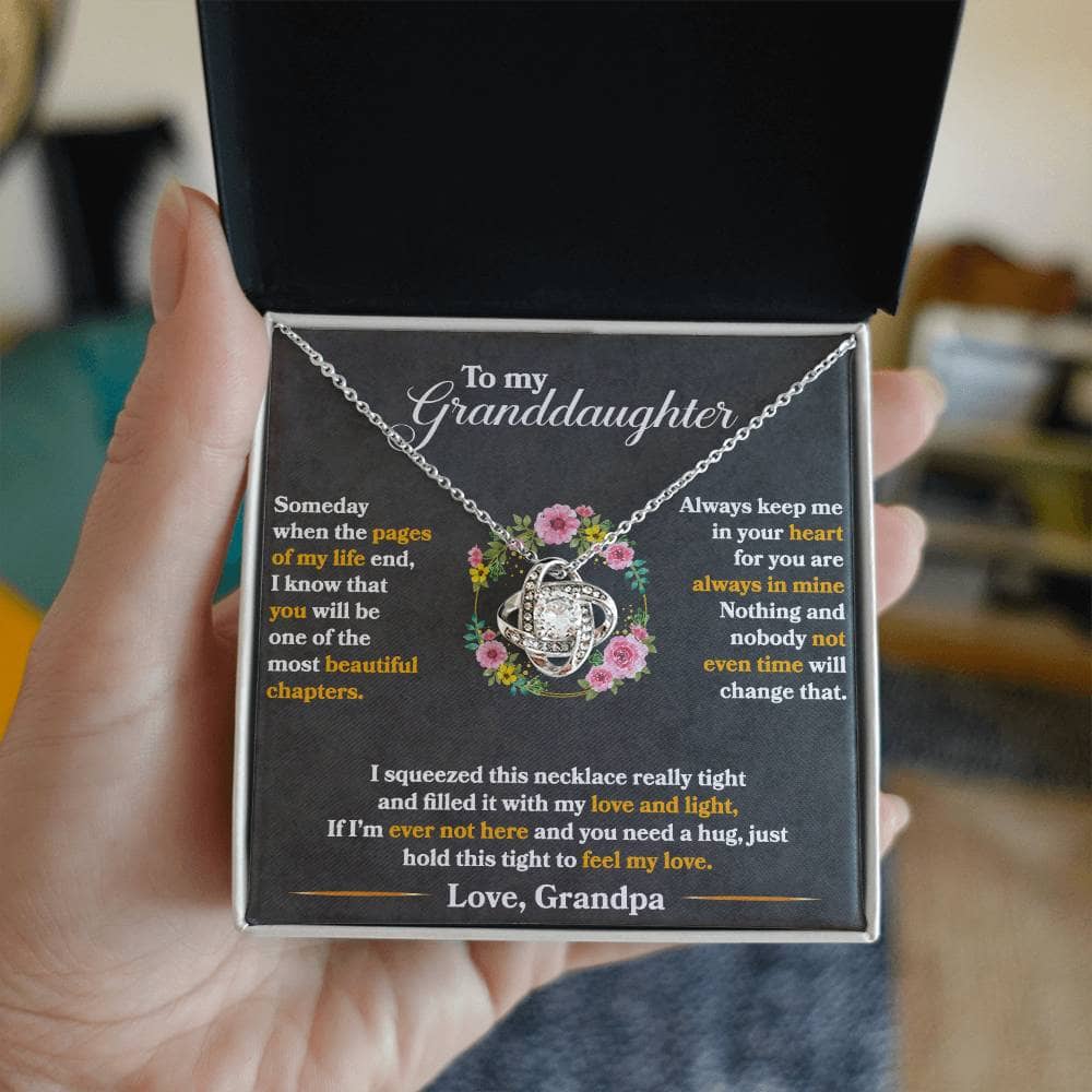 A hand holding a Personalized Necklace for Cherished Granddaughters in a luxurious LED-illuminated box from Bespoke Necklace.