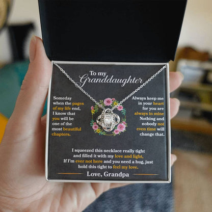 A hand holding a Personalized Necklace for Cherished Granddaughters in a luxurious LED-illuminated box from Bespoke Necklace.