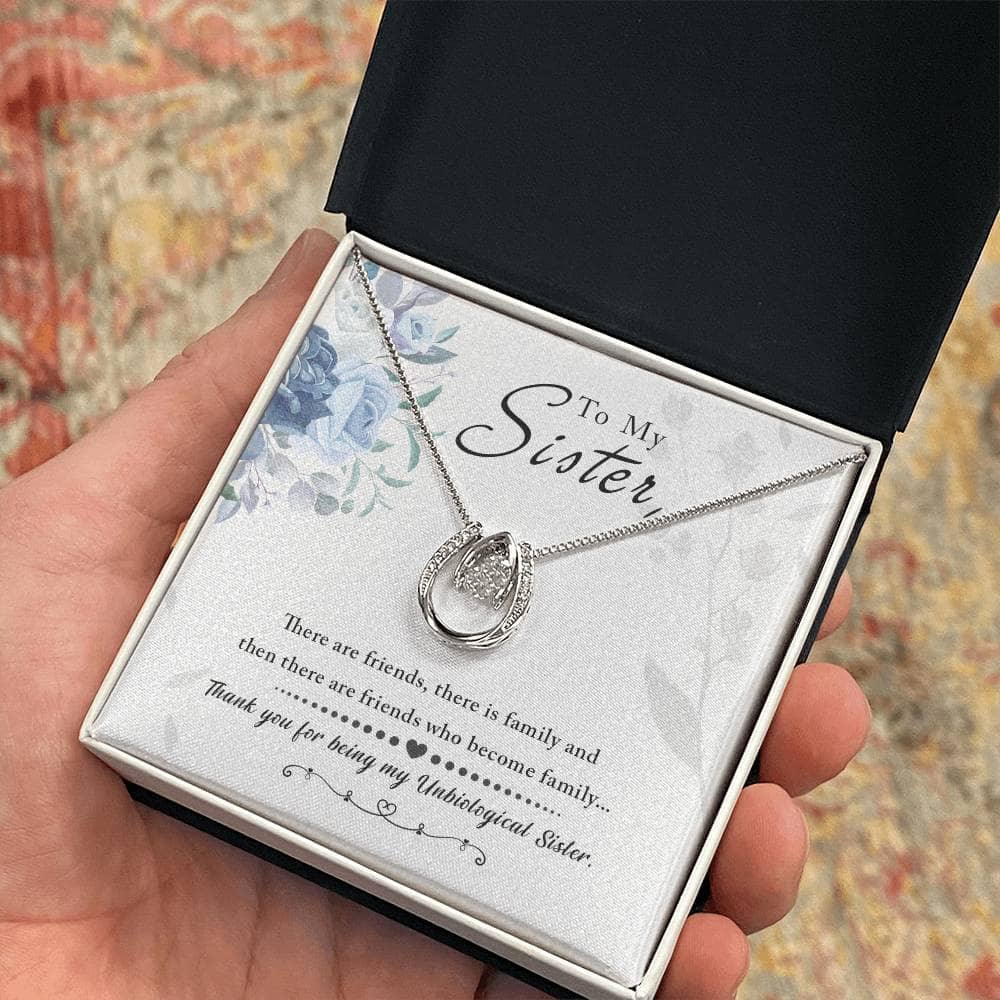 Alt text: A hand holding a Personalized Soul Sister Necklace in a box, symbolizing a profound connection.
