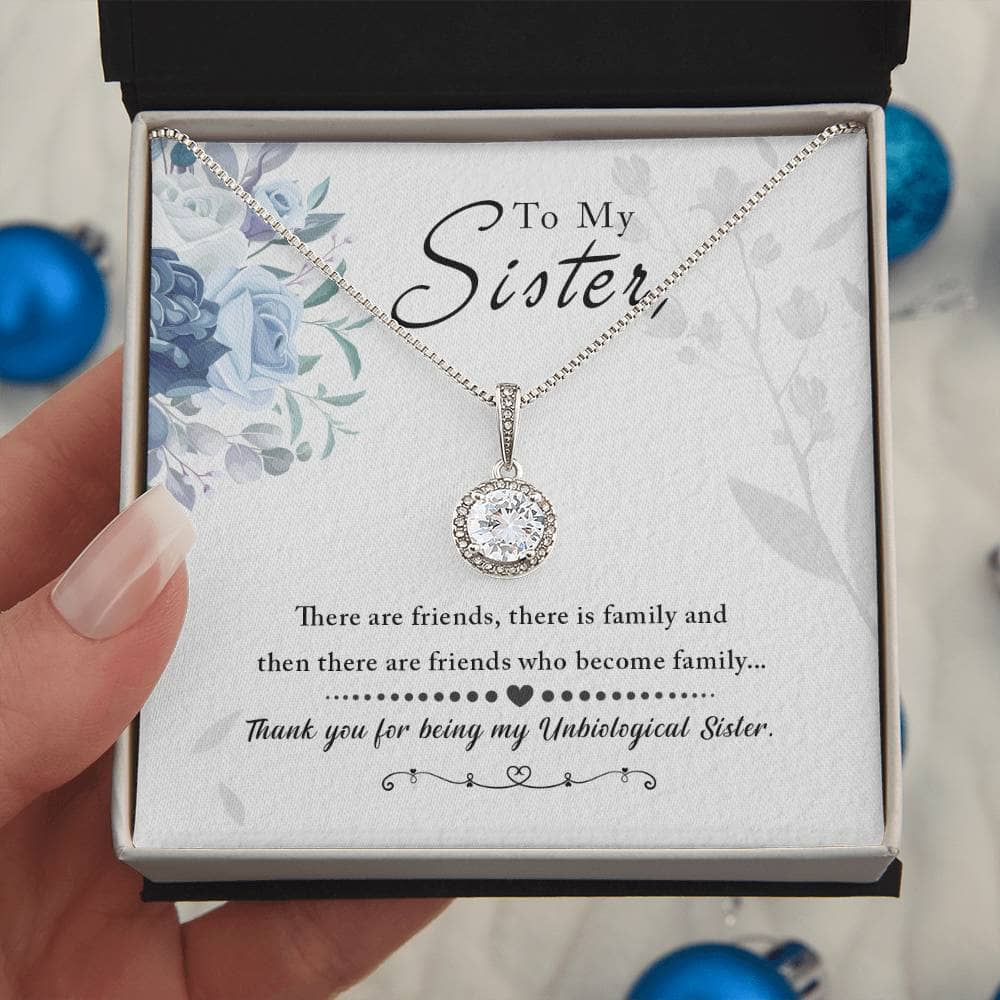 A hand holding a Personalized Soul Sister Necklace, Heart Pendant Design, in a box.