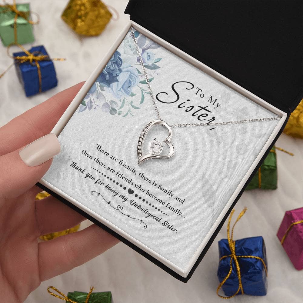 A hand holding a Personalized Soul Sister Necklace with Elegant Heart Pendant in a box.