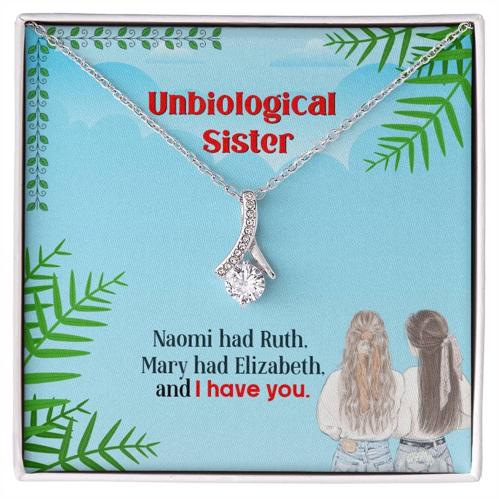 A close-up of a silver pendant necklace in a box, symbolizing the unbreakable bond between unbiological sisters.