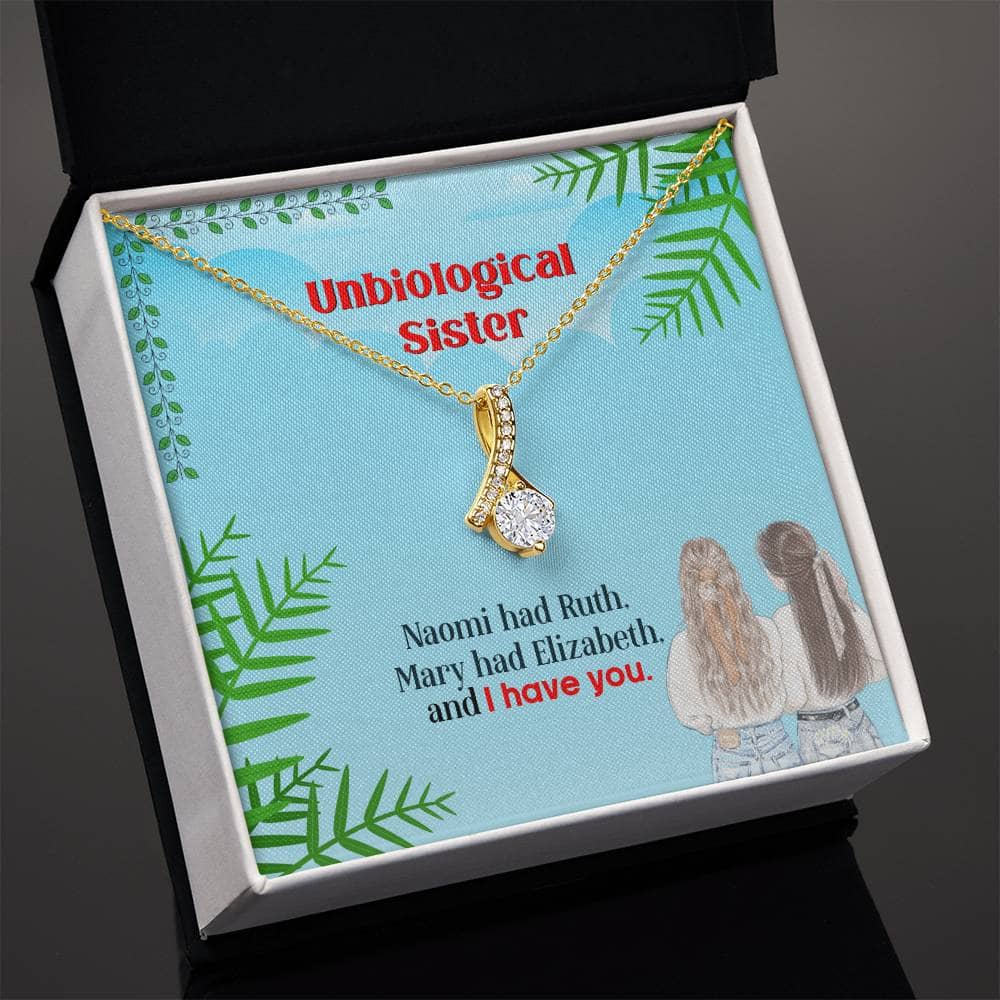 Alt text: "Gold necklace with diamond pendant in box, symbolizing unbreakable bond between unbiological sisters"