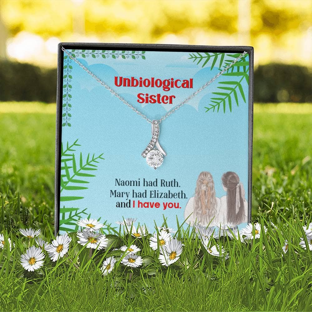 Alt text: "Personalized Unbiological Sisters Necklace in a box with a diamond pendant"