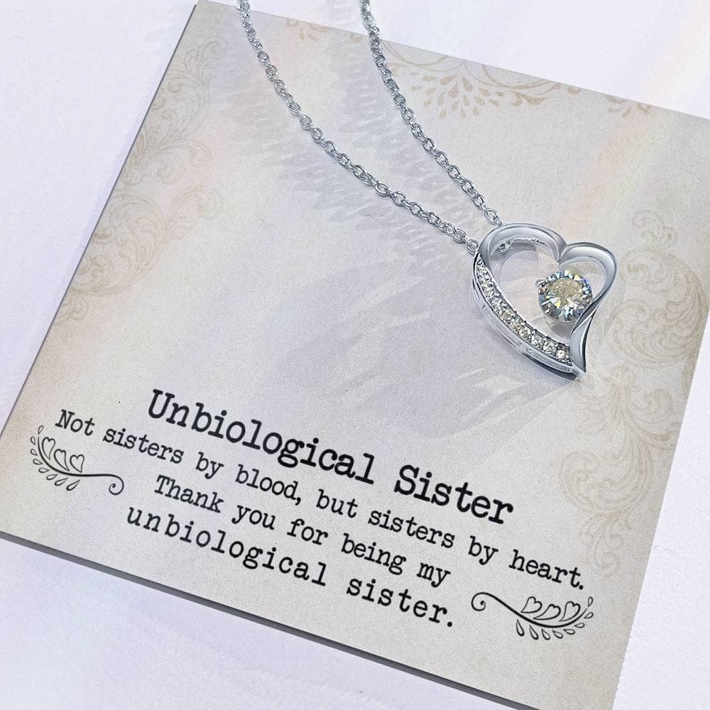 Alt text: "Close-up of Personalized Unbiological Sisters Necklace with diamond pendant on silver chain"