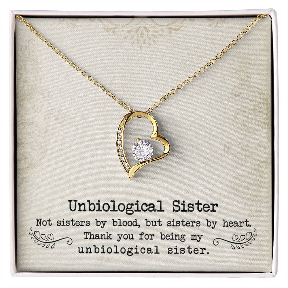 A gold heart necklace with a diamond pendant in a box, symbolizing the unbreakable bond of sisterhood.