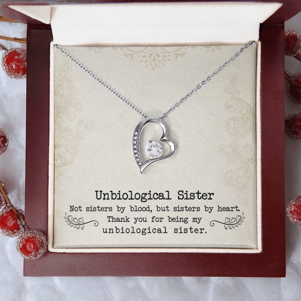 Alt text: "Personalized Unbiological Sisters Necklace in elegant packaging with pendant designs symbolizing sisterhood bonds."