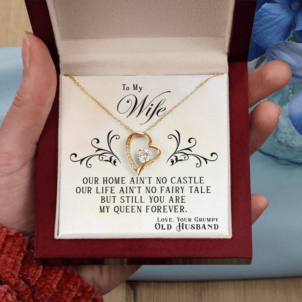 Alt text: "A hand holding a gold heart necklace in a box - Personalized Wife Necklace: Elegant, Forever Love Gift"