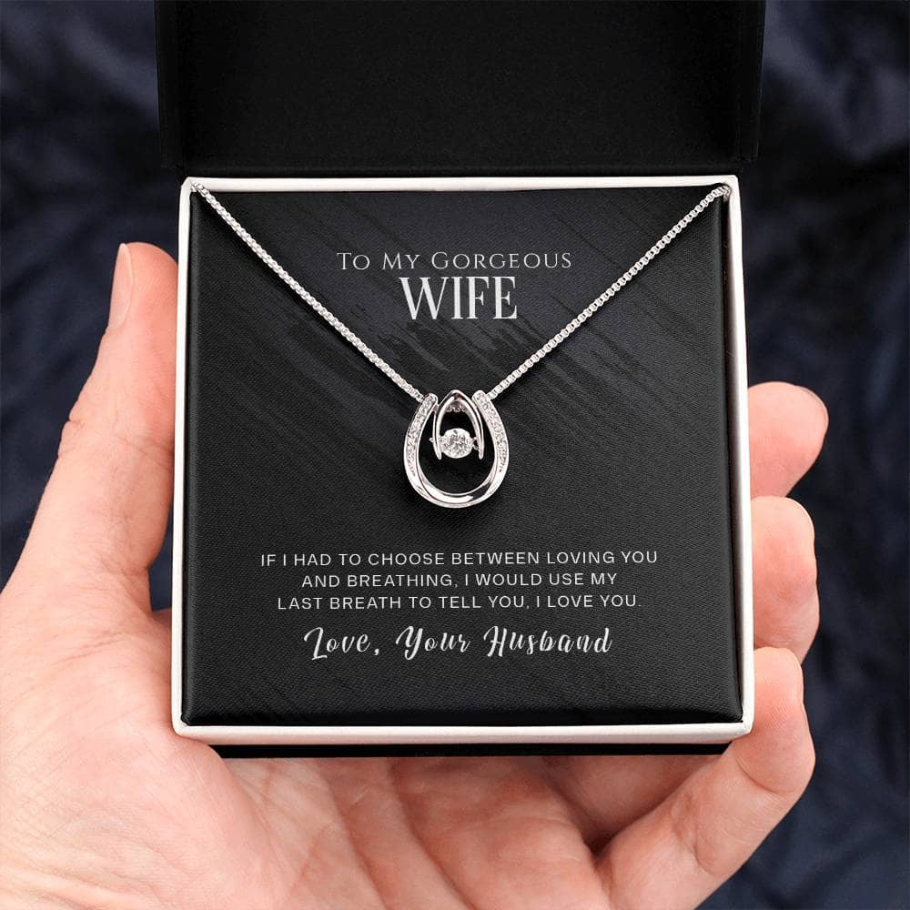 A hand holding a Personalized Wife Necklace in a box, symbolizing enduring love and elegance. Made with cushion-cut cubic zirconia, it adds a shimmering touch to your expression of love. Packaged in a premium gift box for an unforgettable unboxing experience. Perfect for anniversaries, birthdays, or any special occasion.