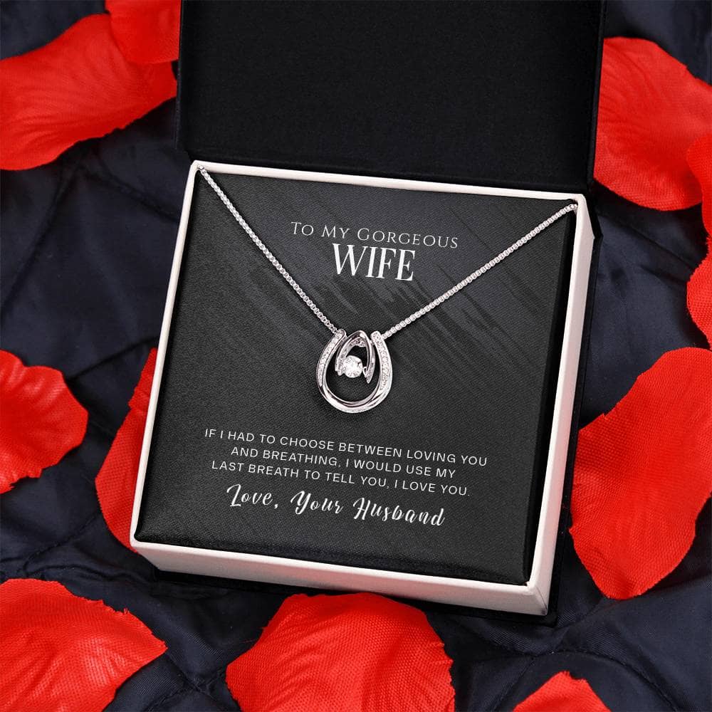 Alt text: "Personalized Wife Necklace - Heart-shaped pendant with cushion-cut cubic zirconia in a gift box on a blanket"