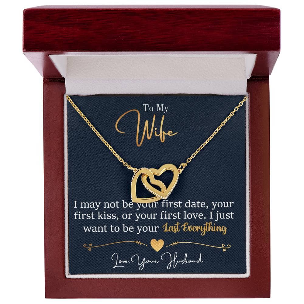 A gold heart necklace in a box, featuring dual heart pendants elegantly garnished with cubic zirconia crystals. Made from high-grade surgical steel with an 18k gold finish. Pendant measures 1.5 cm in height and 2.8 cm in width. Adjustable chain length from 45.72 cm to 55.88 cm. Comes in a soft touch box, upgradeable to a luxury mahogany-style box with LED spotlight.