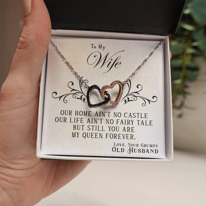 A hand holding a personalized wife necklace in a box, symbolizing love and connection. Crafted with 14k white gold and cubic zirconia, this elegant piece is a cherished memory and a celebration of your unbreakable bond.