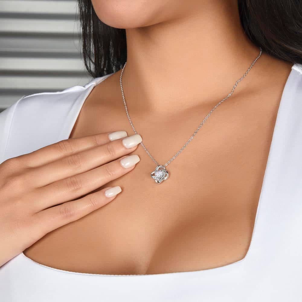 Alt text: "A woman wearing a personalized wife necklace with a heart-shaped pendant and cubic zirconia, symbolizing unity and affection."