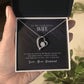 A hand holding a Personalized Wife Necklace - Eternity Love Pendant in a box.