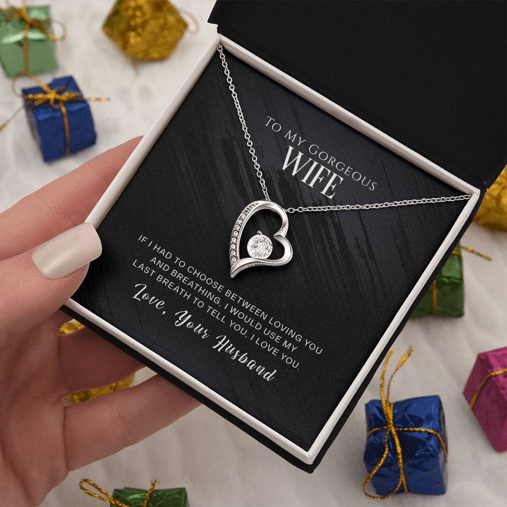Alt text: "Hand holding Personalised Wife Necklace in mahogany-style box with LED lighting"