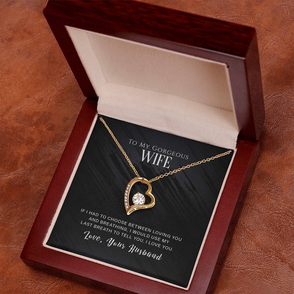 alt: "A mesmerizing Personalised Wife Necklace in a lavishly crafted mahogany-style box with LED lighting, showcasing a heart-shaped pendant and a sparkling cushion-cut cubic zirconia. The perfect gift for special moments, expertly crafted with love and durability."