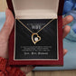 A hand holding a Personalized Wife Necklace in a box, featuring a heart-shaped pendant with a sparkling cubic zirconia.