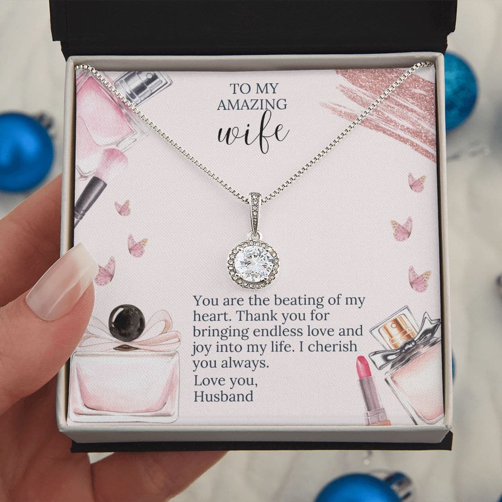A hand holding a necklace in a box, symbolizing everlasting love. A radiant cushion-cut cubic zirconia pendant on a white gold overlay chain. Comes in a stunning presentation box. Limited-time offer, 50% off.