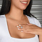 A woman wearing a personalized wife necklace with a heart-shaped pendant and a sparkling cubic zirconia.