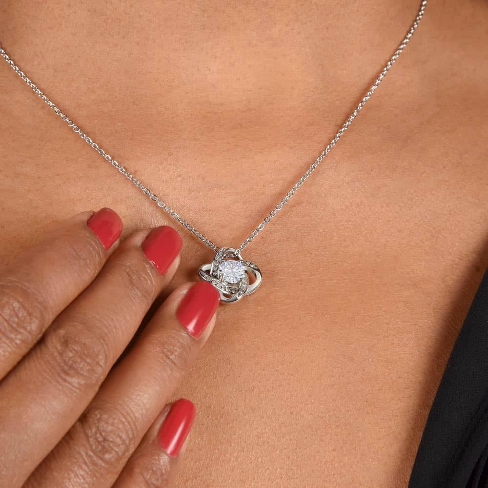 Alt text: "Close-up of a woman wearing a personalized wife necklace with a heart-shaped pendant and a sparkling cubic zirconia."