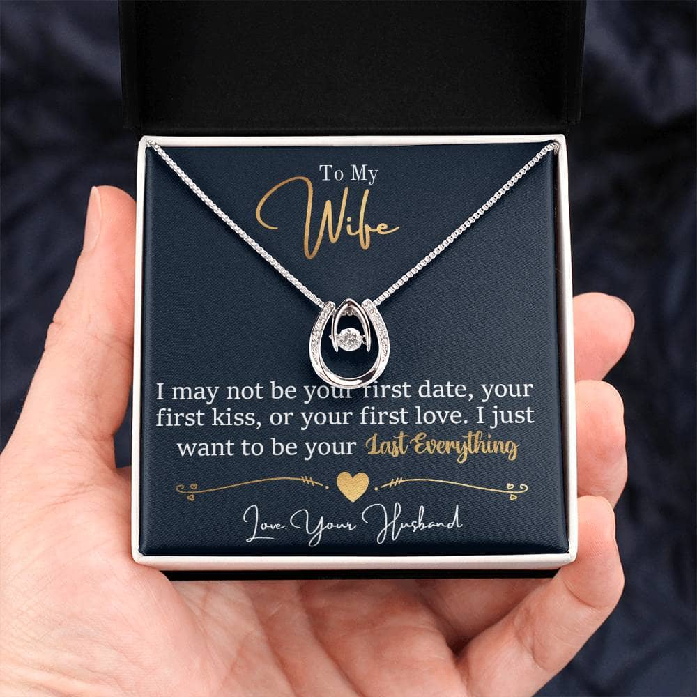 Alt text: "Hand holding personalized wife necklace in a box, symbolizing love and elegance"