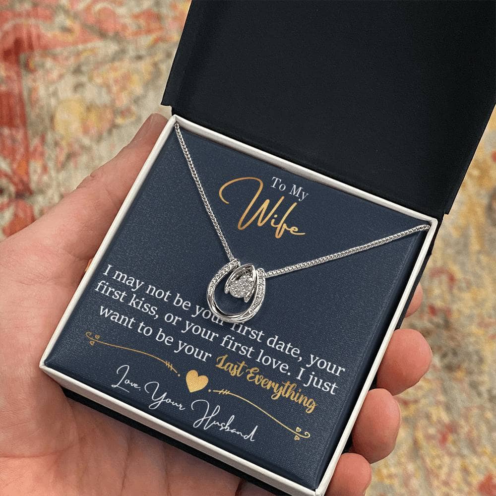 Alt text: "A hand holding a Personalized Wife Necklace in a box, symbolizing love and elegance"