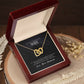 Heart-shaped necklace in box with loving message to wife from husband.