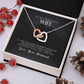 Heart-shaped necklace in a box with love note to wife.