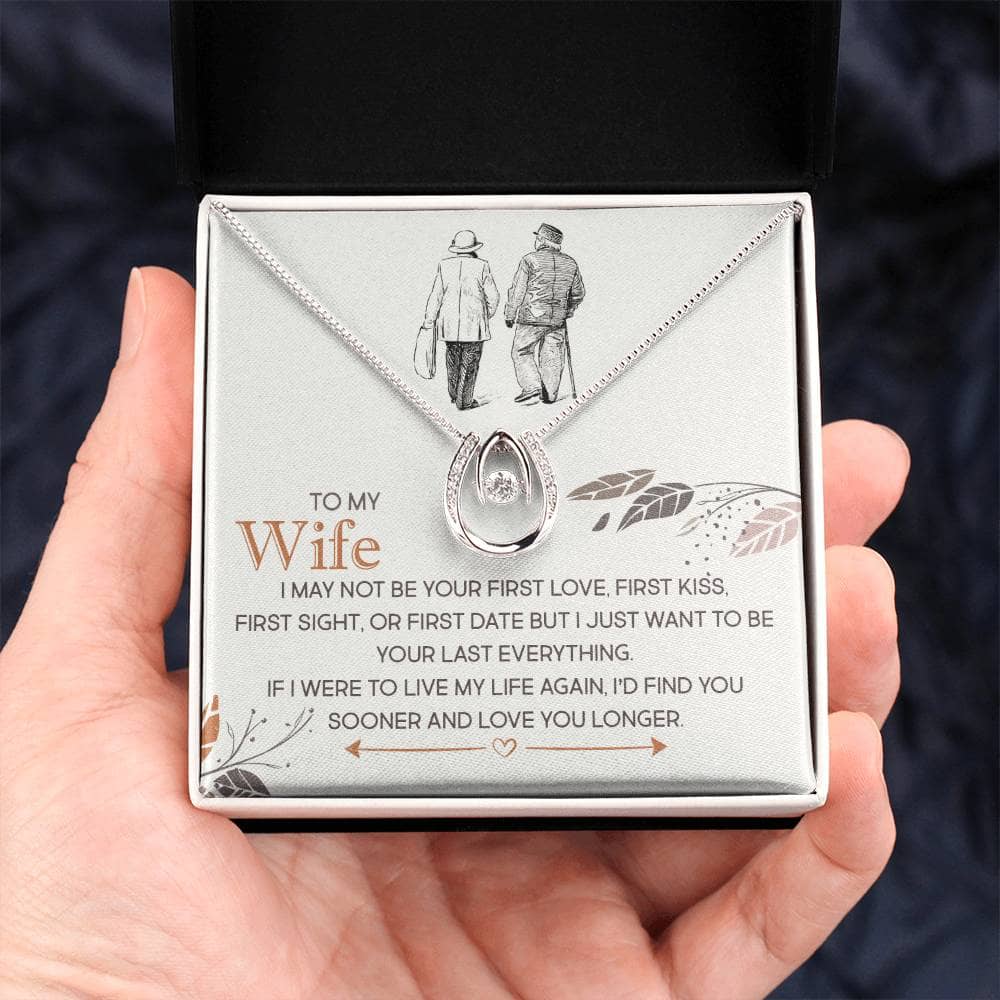Alt text: A hand holding a Personalized Wife Necklace in a mahogany-esque box with LED illumination