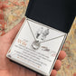 Alt text: A hand holding a Personalized Wife Necklace in a box, symbolizing love and connection.