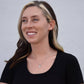 A woman wearing a black shirt and smiling, showcasing the Personalized Wife Necklace - Love Infused Gift.