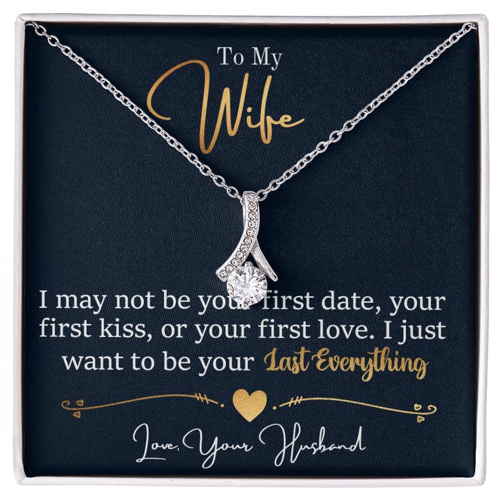 Alt text: "Personalized Wife Necklace: A ribbon-shaped pendant with a sparkling 7mm cubic zirconia, elegantly presented in a box."