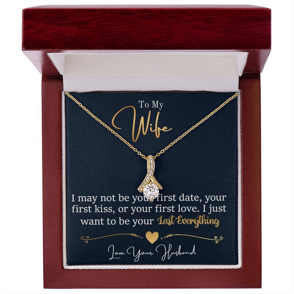 Alt text: "Alluring Beauty necklace in a box - a ribbon-shaped pendant with cubic zirconia on an adjustable chain, symbolizing endless love and connection."